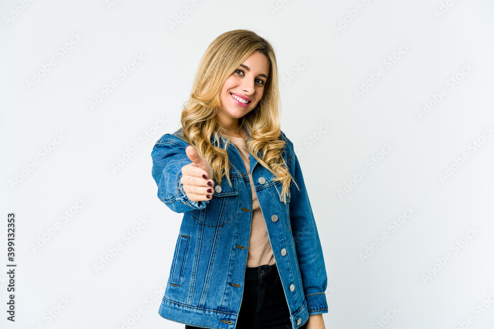 Young caucasian blonde woman stretching hand at camera in greeting gesture. Young caucasian blonde woman stretching hand at camera in greeting gesture.