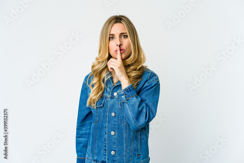 Young caucasian blonde woman keeping a secret or asking for silence.