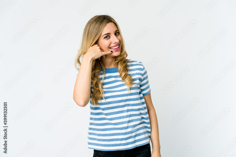 Young caucasian blonde woman showing a mobile phone call gesture with fingers. Young caucasian blonde woman showing a mobile phone call gesture with fingers.