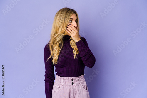 Young caucasian blonde woman thoughtful looking to a copy space covering mouth with hand.