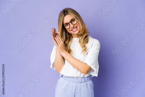 Young caucasian blonde woman feeling energetic and comfortable, rubbing hands confident.