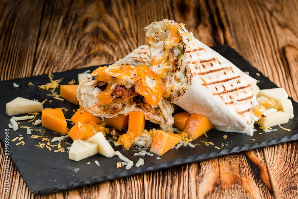 Shawarma Sandwich, Doner Kebab, Chicken Shawarma Traditional Middle Eastern snack. On wooden background Shawarma Sandwich, Doner Kebab, Chicken Shawarma Traditional Middle Eastern snack. On wooden background