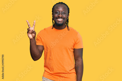 Handsome young african american man wearing casual clothes showing and pointing up with fingers number two while smiling confident and happy.