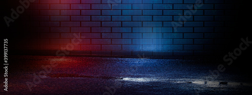 Dark empty brick wall  blue and red neon lights. Night city street  narrow corridor  night lights.