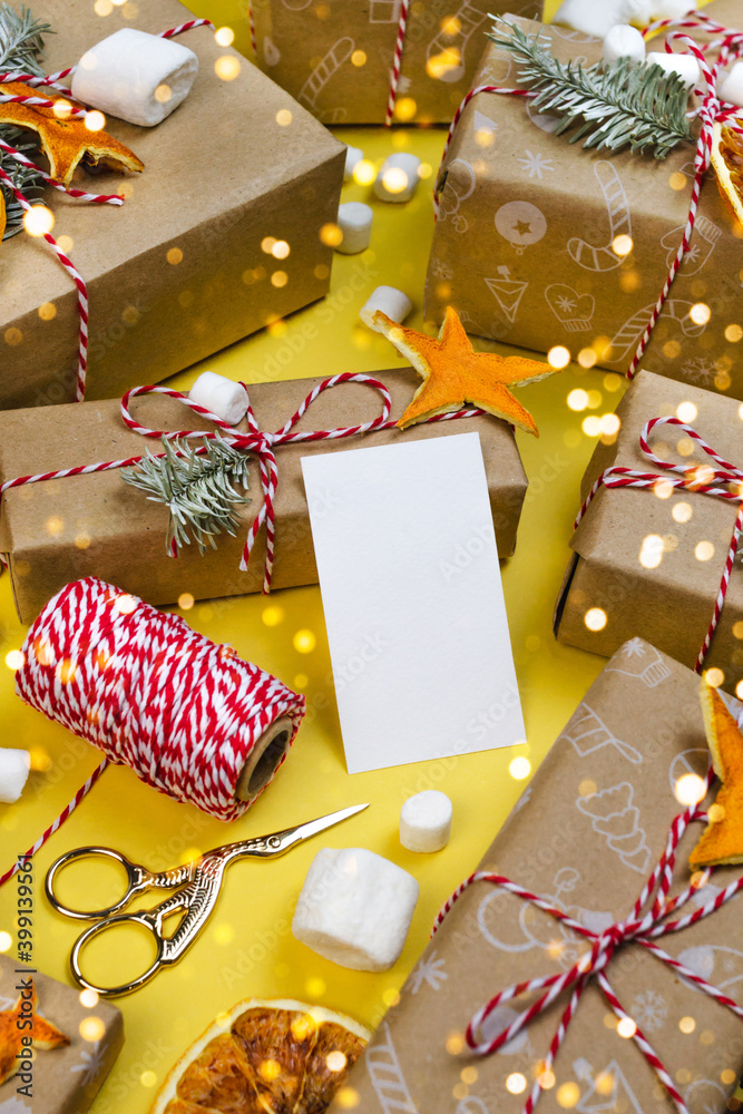 New year gift card, visitcard mockup. Many gift boxes on yellow background. Christmas New year still life
