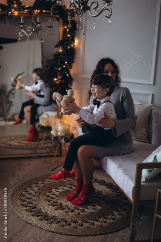 Mother and son together at christmas home with lights and eve. Motherhood  family  christmas  concept