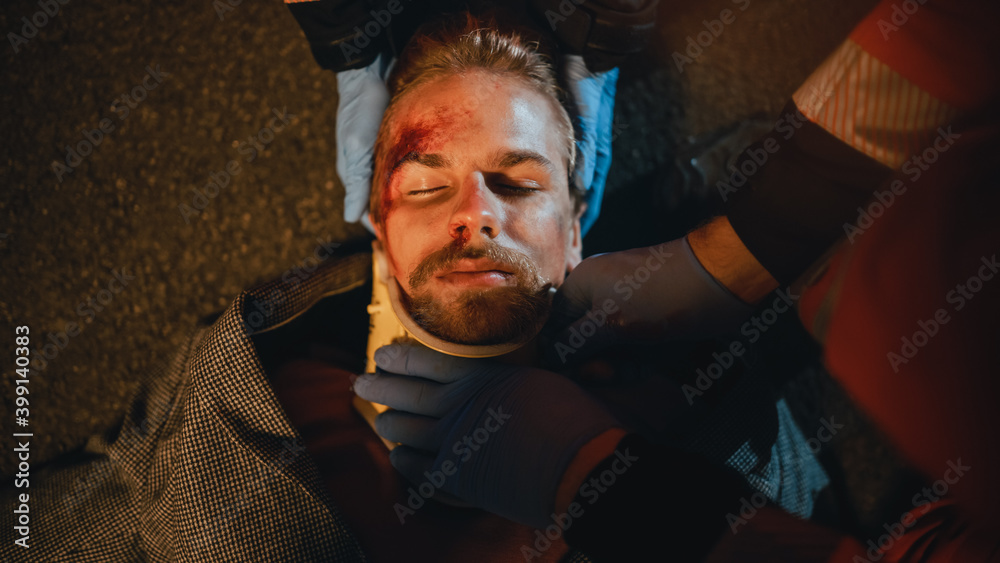 Φωτογραφία Portrait of a Young Injured Man Lying on the Pavement after Traffic Accident on a Street at Night