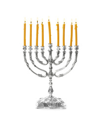 Silver menorah with burning candles on white background. Hanukkah celebration