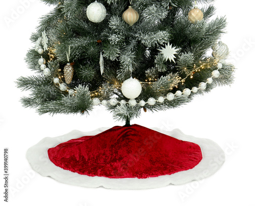 Decorated Christmas tree with red skirt on white background