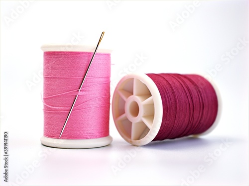 sewing thread and needle ,Sewing spool of thread and scissors isolated on white background	 photo