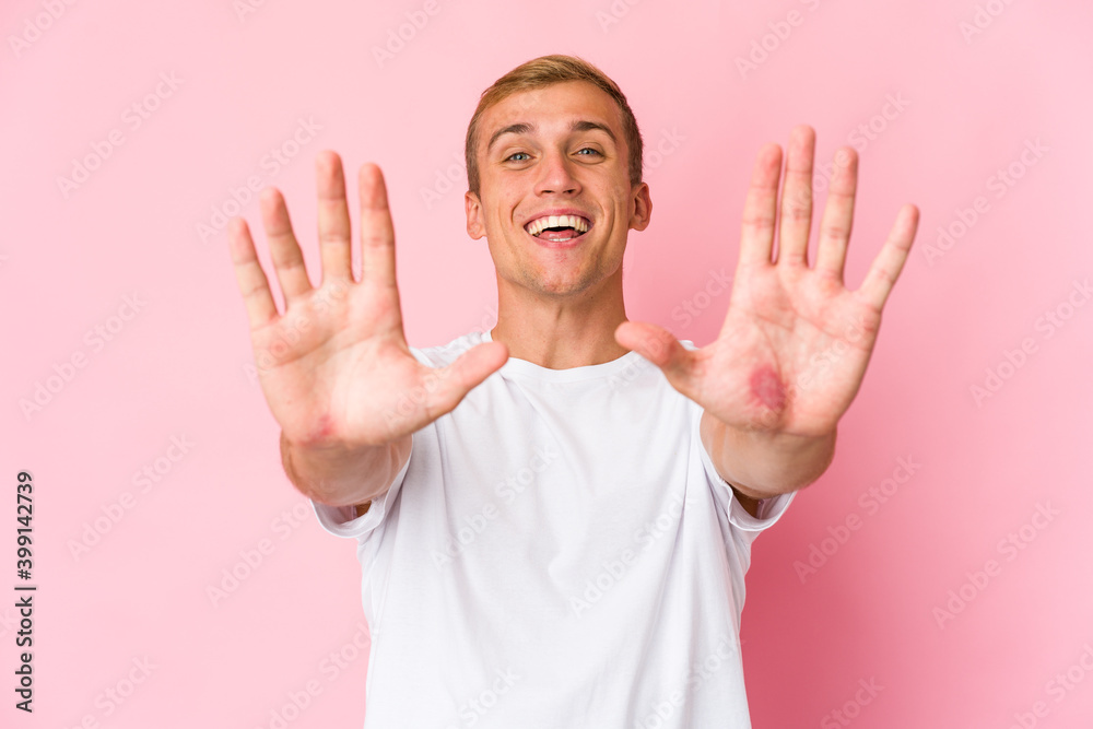 Young caucasian handsome man showing number ten with hands. Young caucasian handsome man showing number ten with hands.