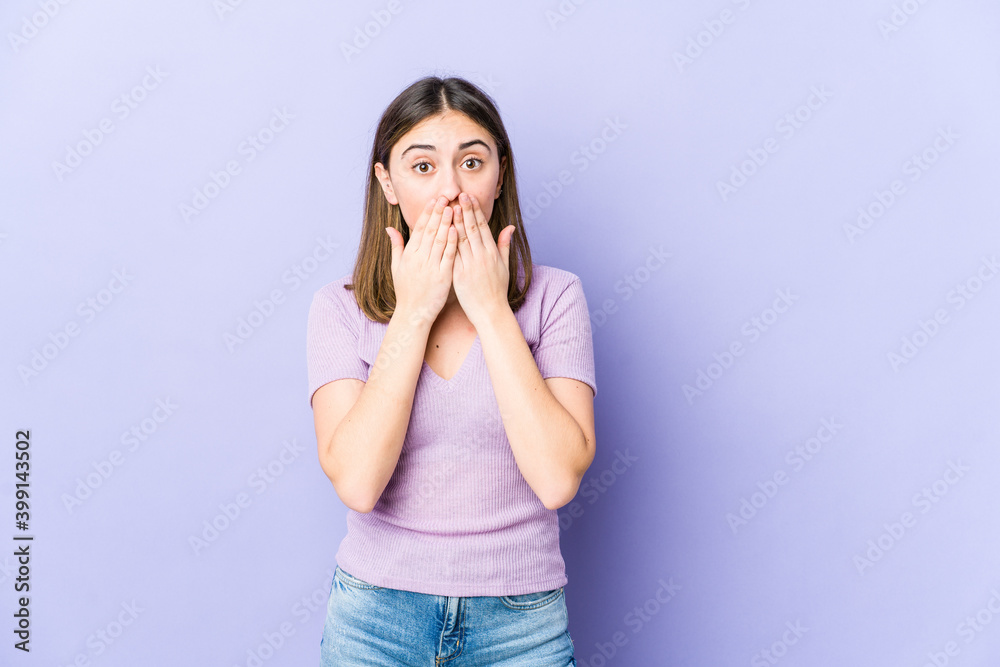 Young caucasian woman shocked, covering mouth with hands, anxious to discover something new. Young caucasian woman shocked, covering mouth with hands, anxious to discover something new.