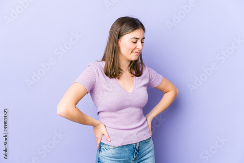 Young caucasian woman suffering a back pain.
