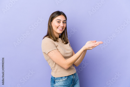 Young caucasian woman holding a copy space on a palm.