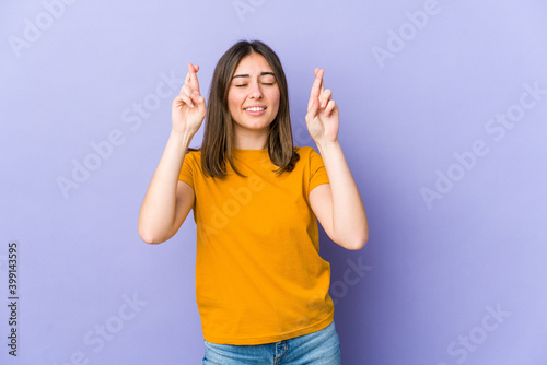 Young caucasian woman crossing fingers for having luck