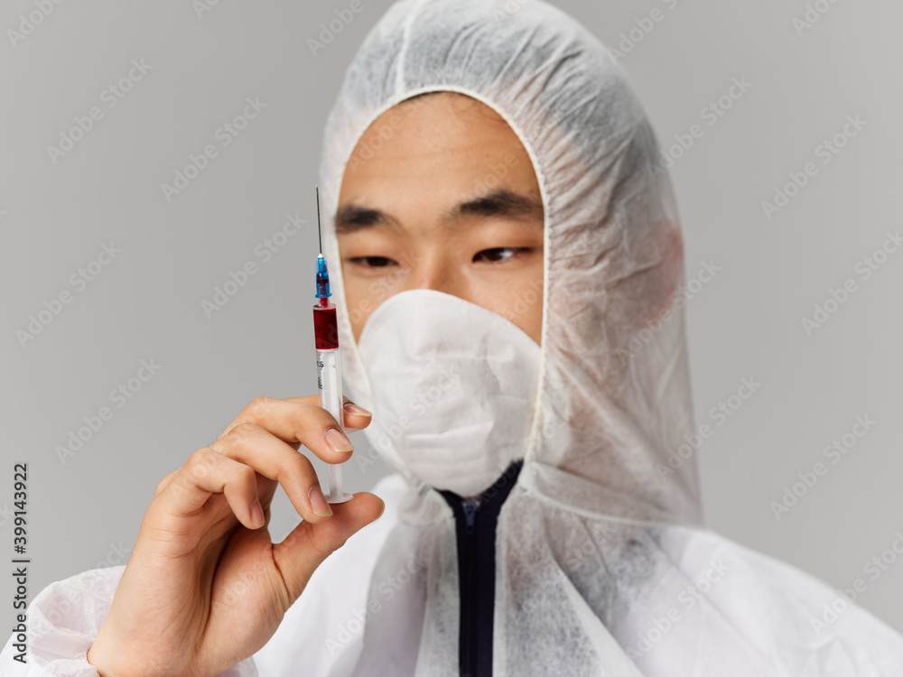 Asian appearance medical protective mask syringe close-up Asian appearance medical protective mask syringe close-up
