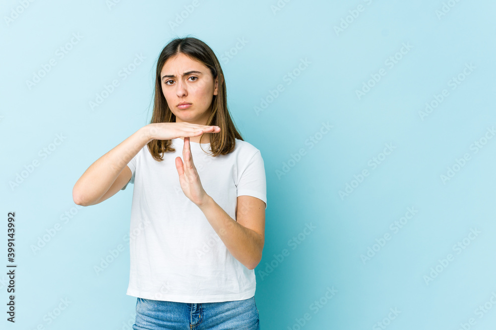 Young caucasian woman showing a timeout gesture. Young caucasian woman showing a timeout gesture.