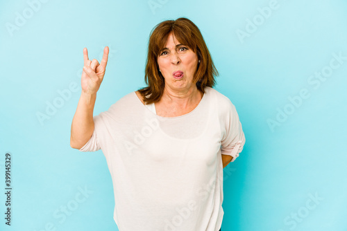 Senior caucasian woman isolated showing rock gesture with fingers