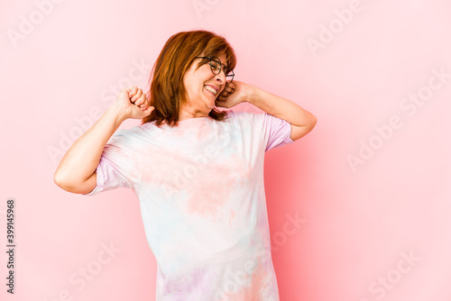 Senior caucasian woman isolated stretching arms, relaxed position.