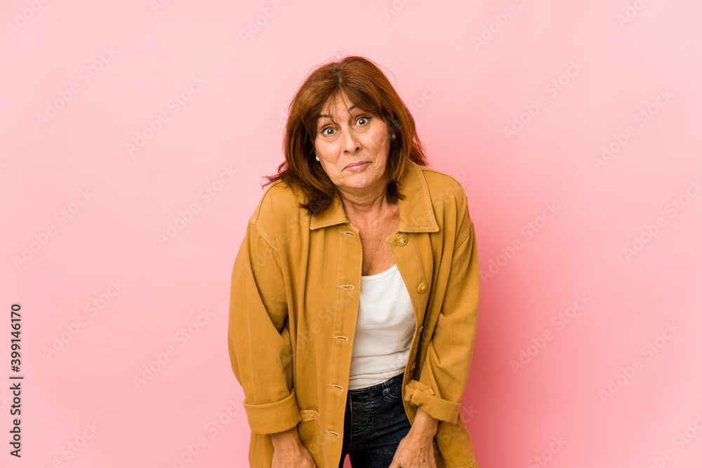 Senior caucasian woman isolated shrugs shoulders and open eyes confused. Senior caucasian woman isolated shrugs shoulders and open eyes confused.
