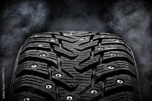 Fotografi winter studded tyre dark moody