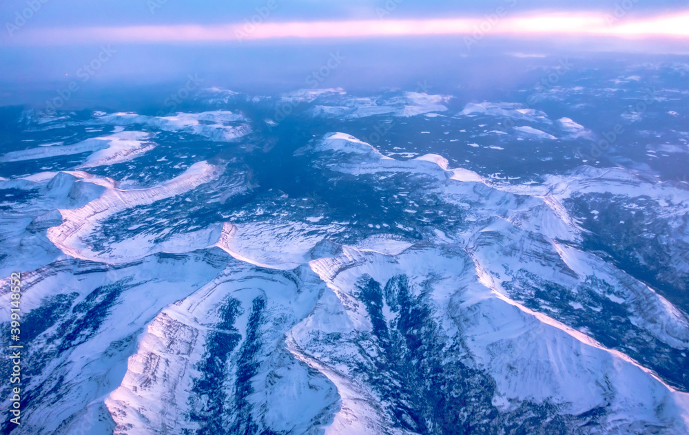 Fototapeta premium flying over rockies in airplane from salt lake city at sunset