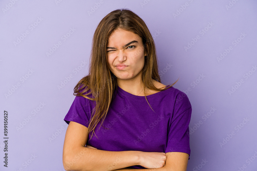 Young skinny caucasian girl teenager on purple background unhappy looking in camera with sarcastic expression. Young skinny caucasian girl teenager on purple background unhappy looking in camera with sarcastic expression.