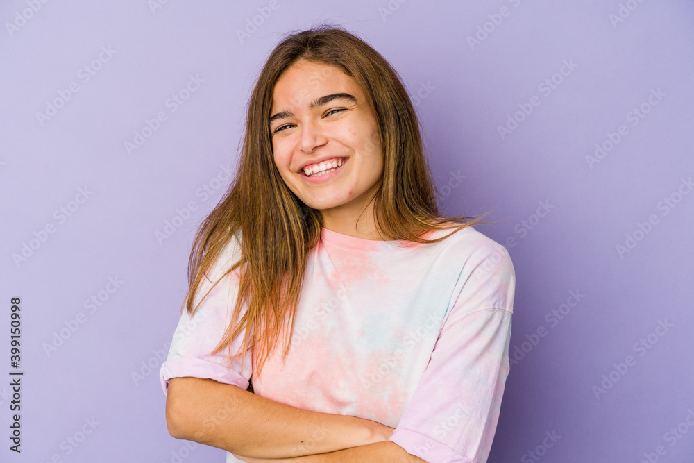 Young skinny caucasian girl teenager on purple background who feels confident, crossing arms with determination. Young skinny caucasian girl teenager on purple background who feels confident, crossing arms with determination.