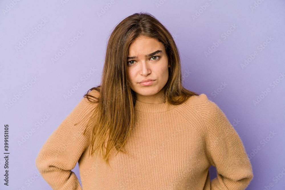 Fototapeta premium Young skinny caucasian girl teenager on purple background sad, serious face, feeling miserable and displeased.