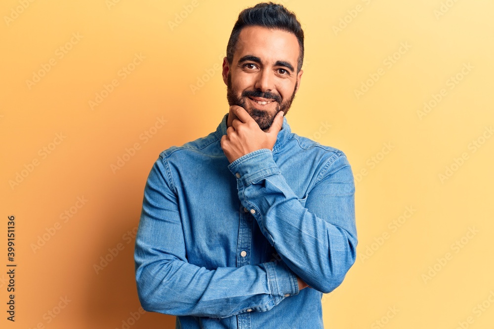 Young hispanic man wearing casual clothes looking confident at the camera smiling with crossed arms and hand raised on chin. thinking positive. Young hispanic man wearing casual clothes looking confident at the camera smiling with crossed arms and hand raised on chin. thinking positive.