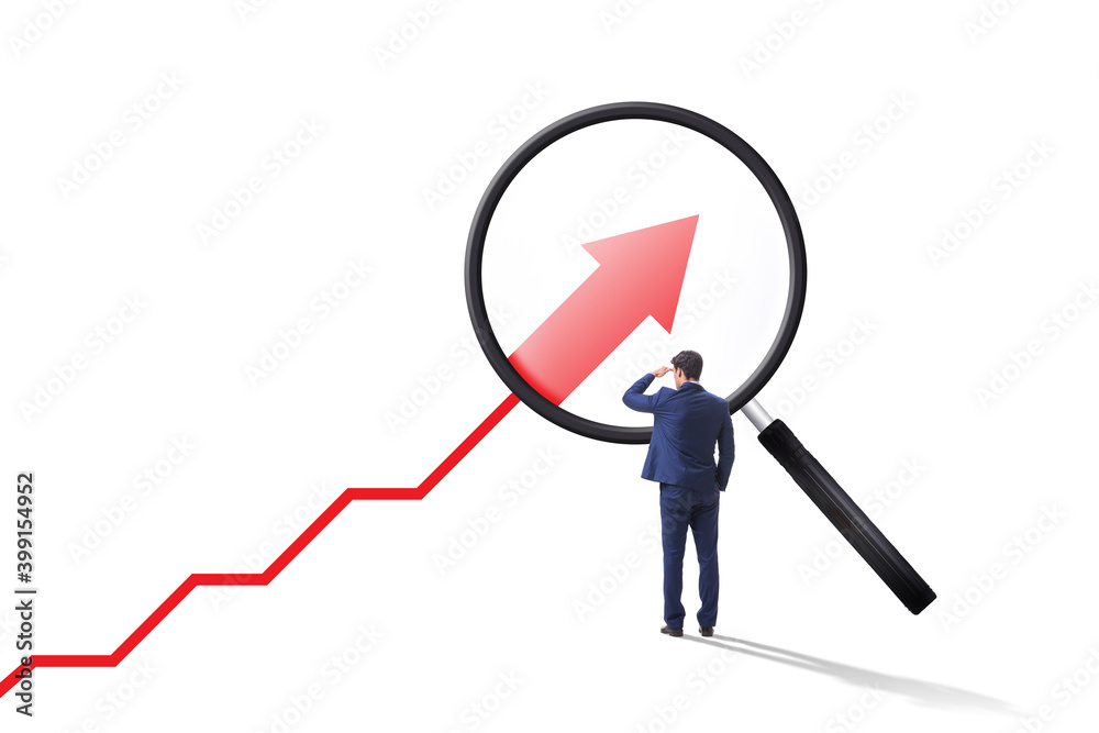 Concept of economic growth with chart and magnifying glass Concept of economic growth with chart and magnifying glass