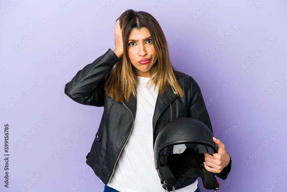 Young indian motorbiker woman isolated being shocked, she has remembered important meeting. Young indian motorbiker woman isolated being shocked, she has remembered important meeting.