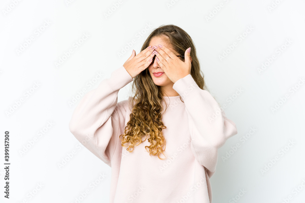 Young caucasian woman afraid covering eyes with hands. Young caucasian woman afraid covering eyes with hands.