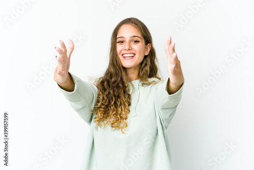 Young caucasian woman celebrating a victory or success, he is surprised and shocked.