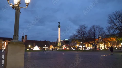 POV walking towards beautiful christmas lights, decorations and statues of Christmas Market during winter at Schlossplatz in Stuttgart, Germany. photo