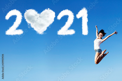 Woman jump with 2021 numbers and heart symbol