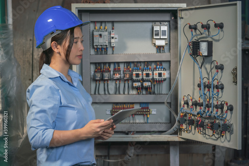 electrical engineer checking and maintenance electric control switchboard