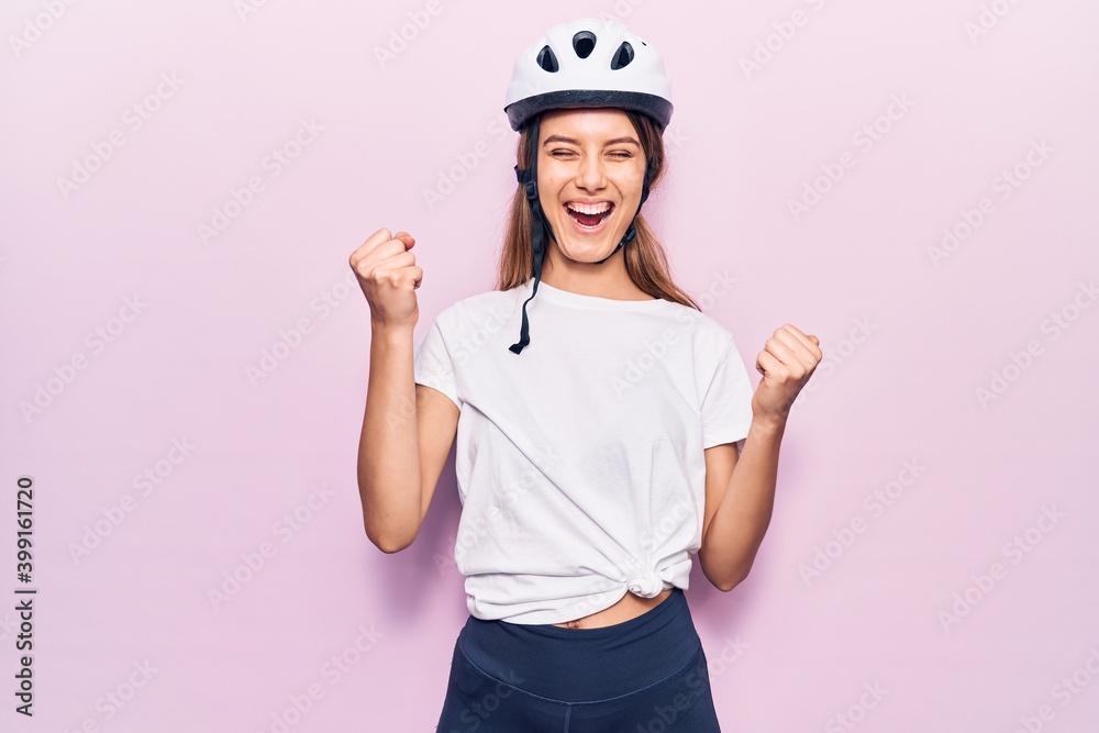 Young beautiful girl wearing bike helmet celebrating surprised and amazed for success with arms raised and eyes closed Young beautiful girl wearing bike helmet celebrating surprised and amazed for success with arms raised and eyes closed