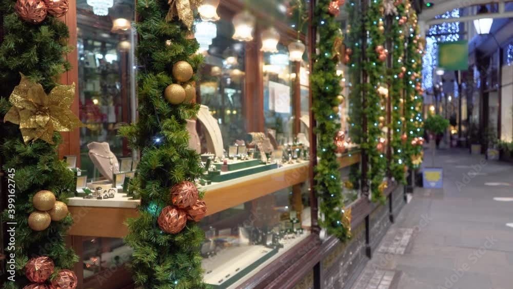 Jewelry store windows are decorated with Christmas decorations, side view