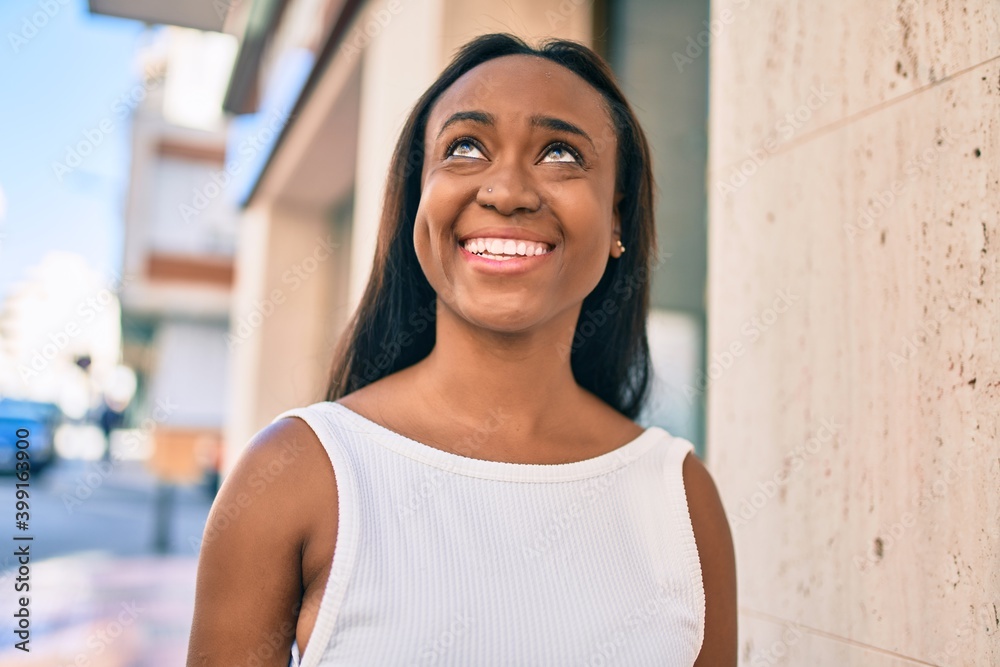 Young african american woman smiling happy walking at the city.