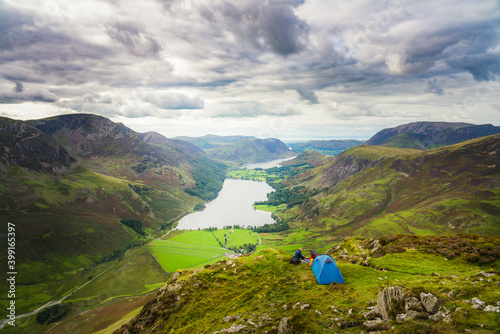 Photography Couple campiong on top of Haystacks peak overlooking Buttermere lake in Lake District