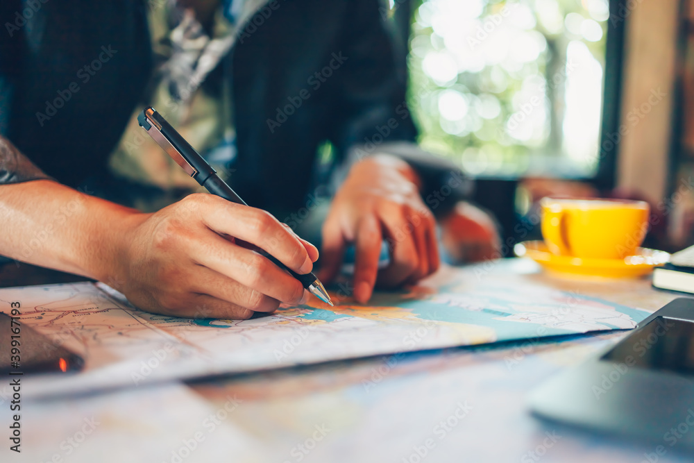 Tourist hold pen and marking planning vacation with map and other travel accessories on the table. Travel, holiday, vocation concept. Tourist hold pen and marking planning vacation with map and other travel accessories on the table. Travel, holiday, vocation concept.