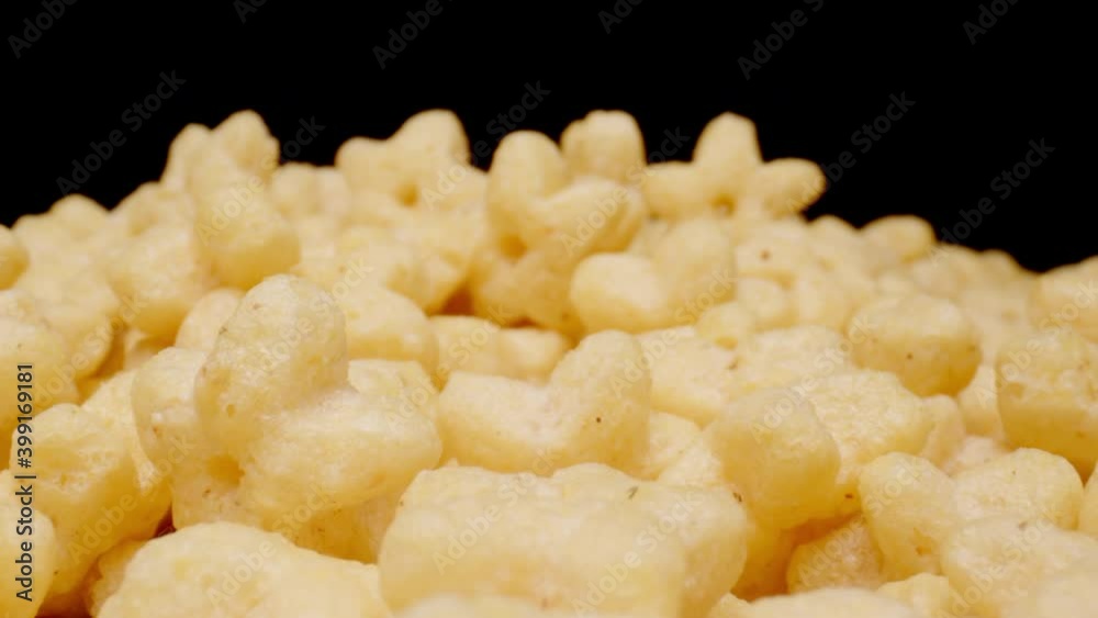 MACRO: Motion over figural sweet corn stars on a black background MACRO: Motion over figural sweet corn stars on a black background