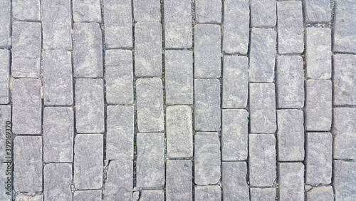 Sidewalk. Rectangular cobblestones. Construction industry. Stone background. Copy space for text.