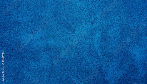 blue leather texture closeup with detailed background. blue abstract uneven grunge background texture of interior classic chamois leather fabric. 