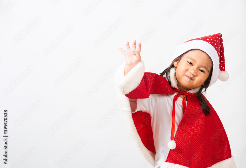 Portrait of Asian little cute girl smiling, Kid dressed in Santa Claus hat the concept of holiday Christmas Xmas day or Happy new year, studio shot isolated white background with copy space for text Portrait of Asian little cute girl smiling, Kid dressed in Santa Claus hat the concept of holiday Christmas Xmas day or Happy new year, studio shot isolated white background with copy space for text