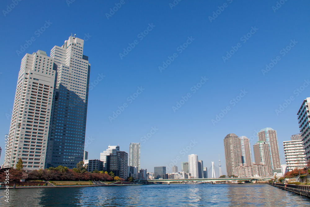 Naklejka premium High-rise buildings against blue sky in Tokyo