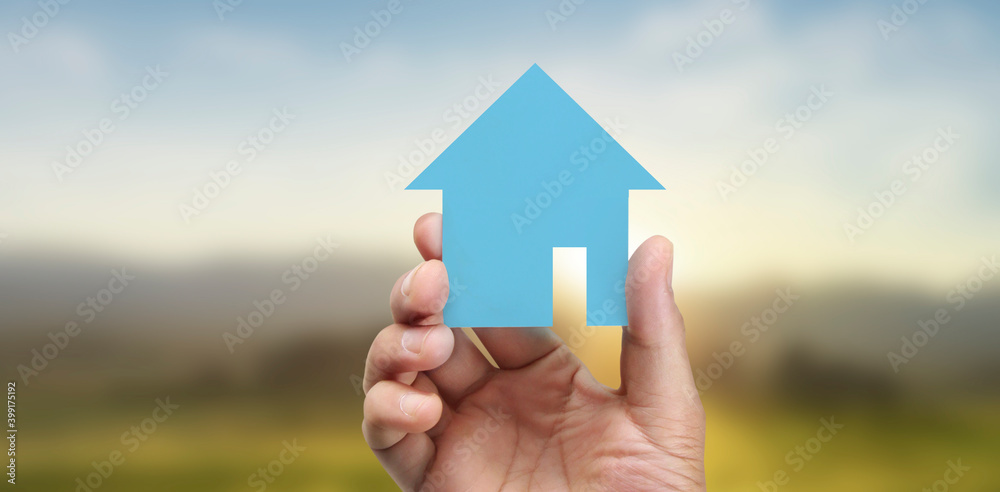 Naklejka premium Hands holding paper house, family home protecting insurance concept