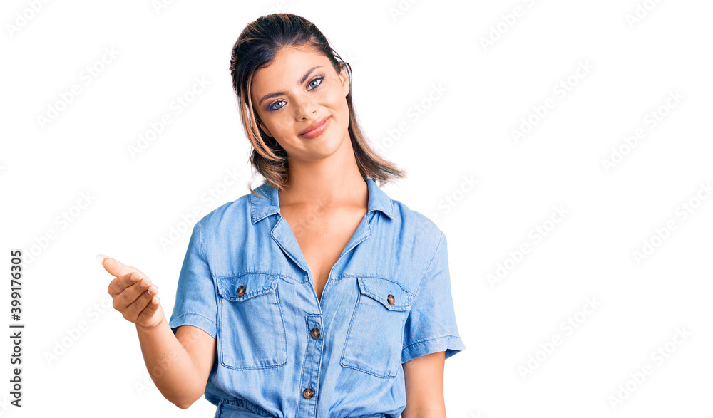 Young beautiful woman wearing casual clothes smiling friendly offering handshake as greeting and welcoming. successful business. Young beautiful woman wearing casual clothes smiling friendly offering handshake as greeting and welcoming. successful business.
