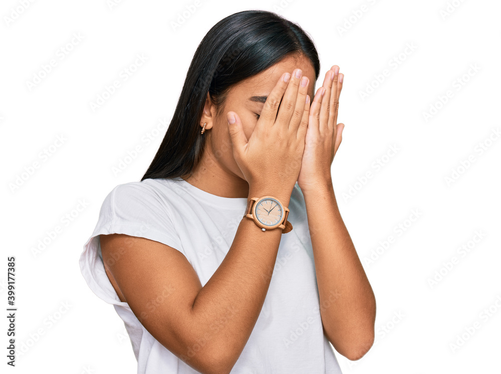 Young asian woman wearing casual white t shirt with sad expression covering face with hands while crying. depression concept. Young asian woman wearing casual white t shirt with sad expression covering face with hands while crying. depression concept.